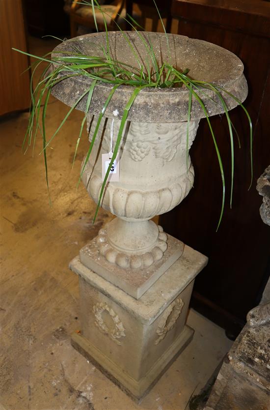 A reconstituted stone urn on plinth, height approx. 102cm, width 42cm